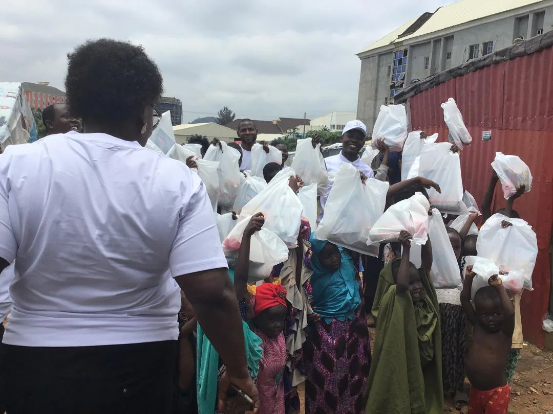 Children hold up relief packages distributed during the LAHF visit