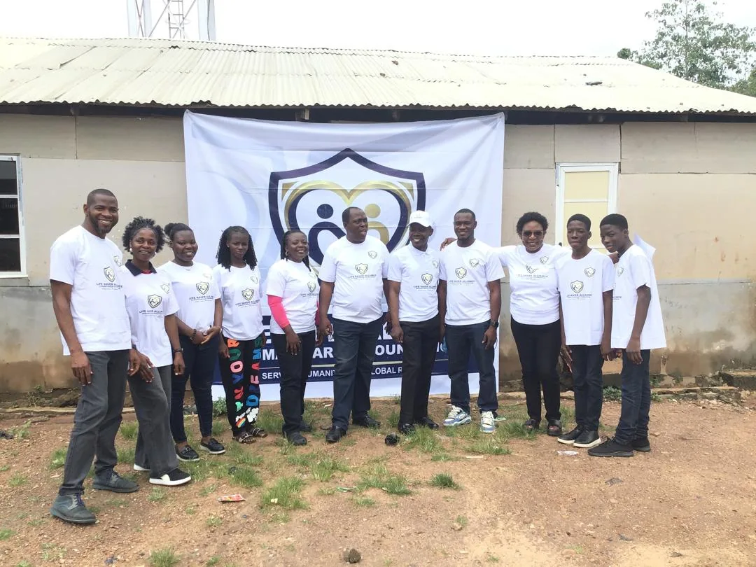 Members of the LAHF team standing together during a community visit in Durumi 1